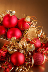 Christmas composition of Christmas tree toys on a blurred gold background