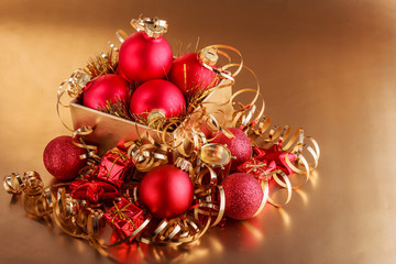 Christmas composition of Christmas tree toys on a blurred gold background