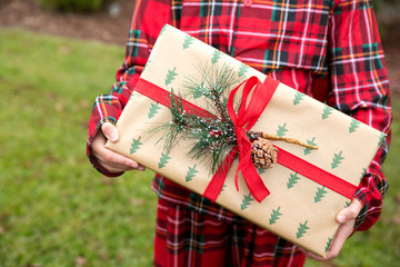 Child Girl Standing Outside Holding a Wrapped Present
