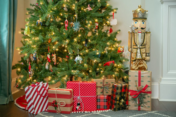 Christmas Presents in Front of a glowing Christmas Tree with White Lights