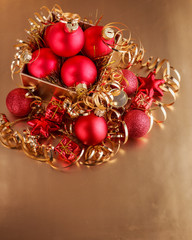 Christmas composition of Christmas tree toys on a blurred gold background