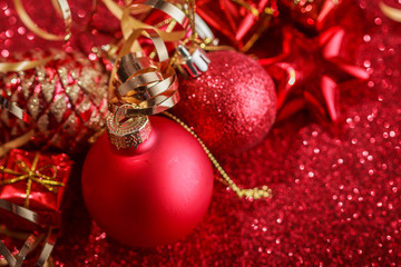 Christmas composition of Christmas tree toys on a blurred red background