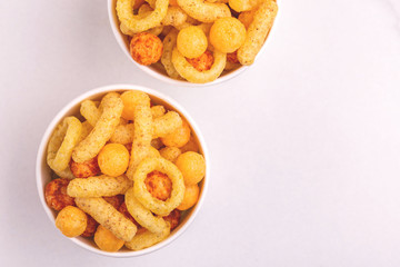 Assorted puff corn snacks in two paper cup