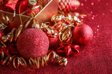 Christmas composition of Christmas tree toys on a blurred red background
