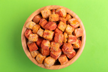 Bacon flavored crackers in wooden bowl on bright colored background