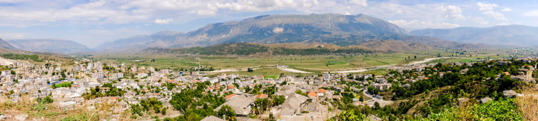A panoramic view over town Gjirokaster and river Lumi Drino (Albania) from the Ali Pasha's  fortress - obrazy, fototapety, plakaty