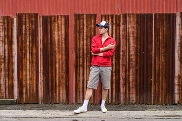 Profile view of young bearded man thinking while wearing cap wit