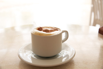 cup of cappuccino on the table. Isolated outdoor