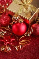 Christmas composition of Christmas tree toys on a blurred red background