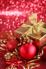 Christmas composition of Christmas tree toys on a blurred red background