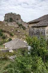 Silver roofs of Gjirokaster (Albania) with ruins of the fortress of Ali Pasha in the background