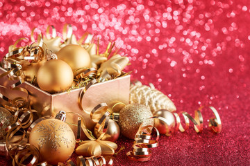 Christmas composition of Christmas tree toys on a blurred red background