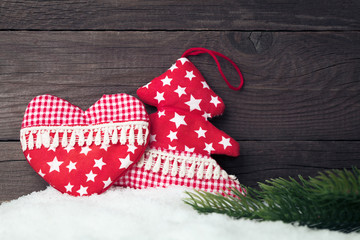 Christmas decoration on snow over wooden background