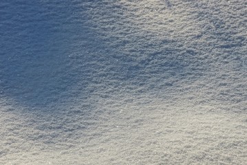 natural white snow texture in sunlight and shade