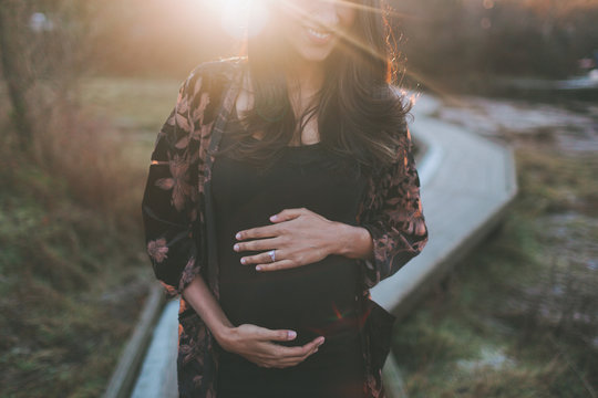 A Beautiful Pregnant Indian Woman At Sunset.