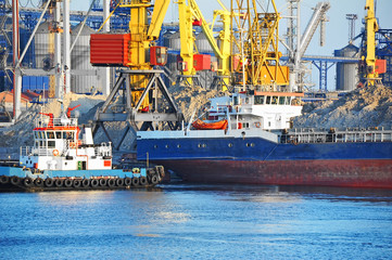 Tugboat assisting bulk cargo ship