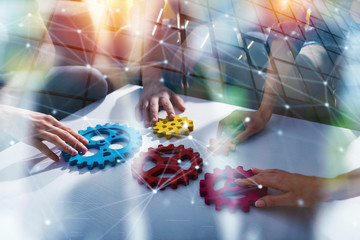 Business team connect pieces of gears. Teamwork, partnership and integration concept. double...