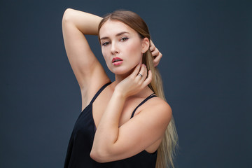 Fototapeta premium Beautiful blonde woman in black dress