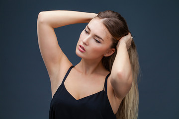 Obraz premium Beautiful blonde woman in black dress