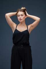 Fototapeta premium Beautiful blonde woman in black dress