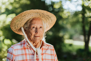 Portrait of a happy senior woman with a straw hat