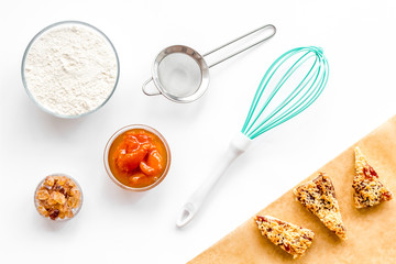 Cook cookies at home concept. Fresh cookies near whisk, flour, sieve on white background top view