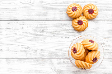 Homemade cookies. Kurabe in glass bowl on white wooden background top view copy space