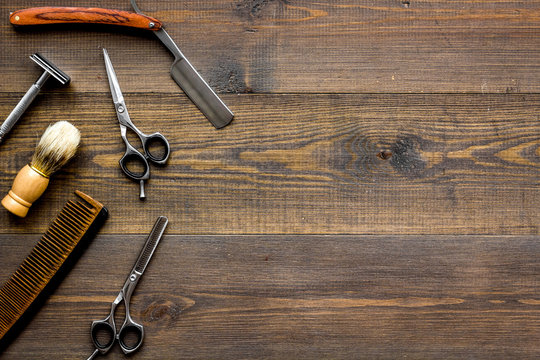 Instruments of male hairdresser barbershop top view on wooden background copyspace