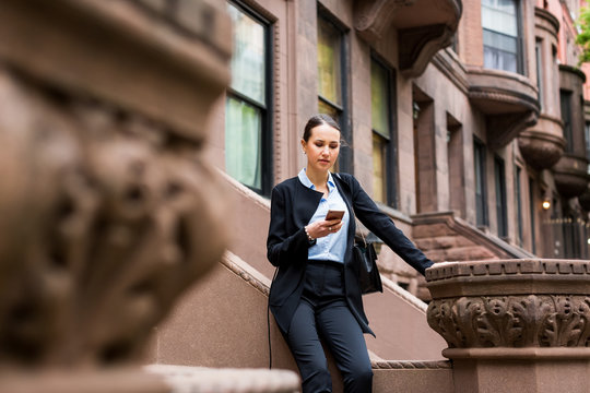 Businesswoman using technology outdoor in the city.  NY