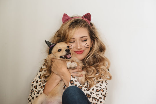 A teenage girl and her dog dressed up for halloween