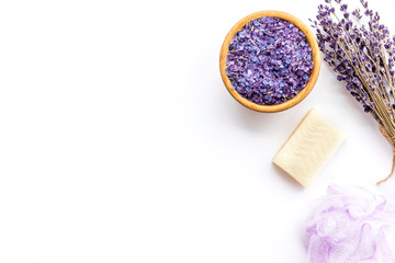 Obraz na płótnie Canvas Spa set with lavender spa salt. Purple spa salt near dry lavender branches and washcloth on white background top view copy space