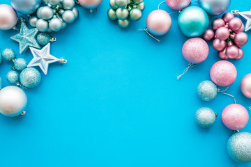 Toys for New Year tree 2019 background. Blue and pink balls and stars on blue background top view space for text border