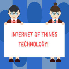 Handwriting text Internet Of Things Technology. Concept meaning IT modern technologies online network Male and Female in Uniform Standing Holding Blank Placard Banner Text Space