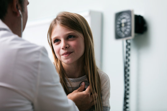 Exam: Doctor Uses Stethoscope To Listen To Girl's Heart