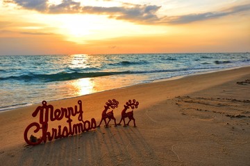 Happy new year concept, Merry Christmas put no sand beach in sunset.
