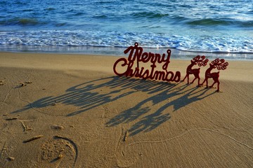 Happy new year concept, Merry Christmas put no sand beach in sunset.