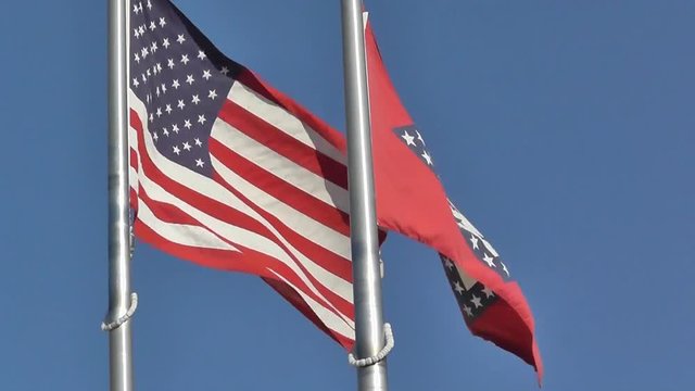 US United States Flag and Arkansas Flag Fly Together from a Flagpole