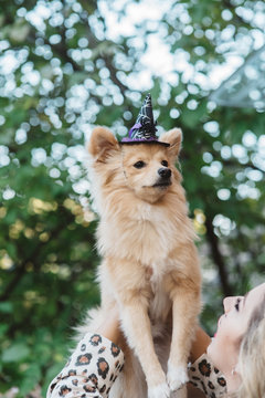 A teenage girl and her dog dressed up for halloween
