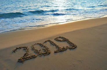 Happy new year concept, 2019 put on sand beach in sunrise.