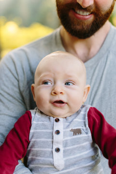 Baby Making Funny Fave in Father's Arms