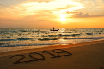 Happy new year concept, 2019 put on sand beach in sunset.