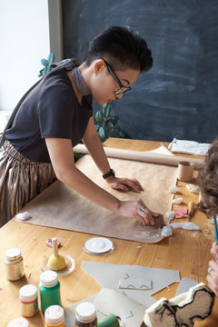 Woman making prints on kraft paper