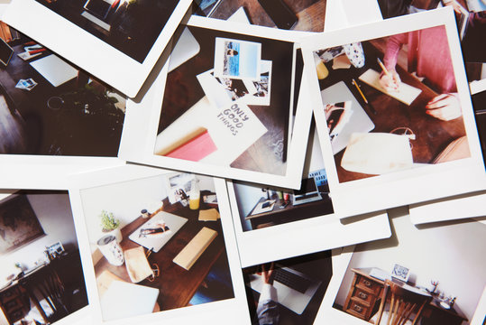 Arrange of polaroids with home workspace