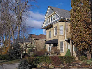 row of vintage yellow brick houses with gables