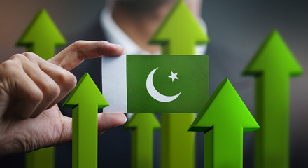 Nation Growth Concept, Green Up Arrows - Businessman Holding Card Pakistan Flag