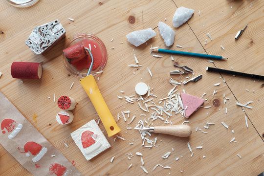 Messy table with linocut tools
