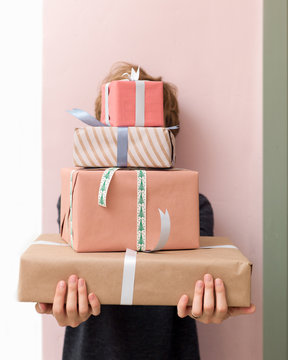 Woman behind gift boxes