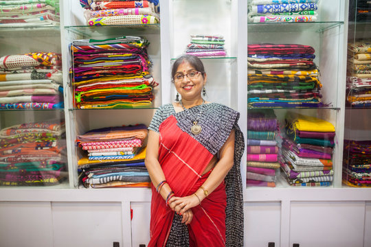 A Businesswoman who sells traditional Indian dress in a small shop
