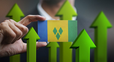 Nation Growth Concept, Green Up Arrows - Businessman Holding Card of Saint Vincent and the...