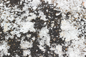 Texture of asphalt road with melted snow